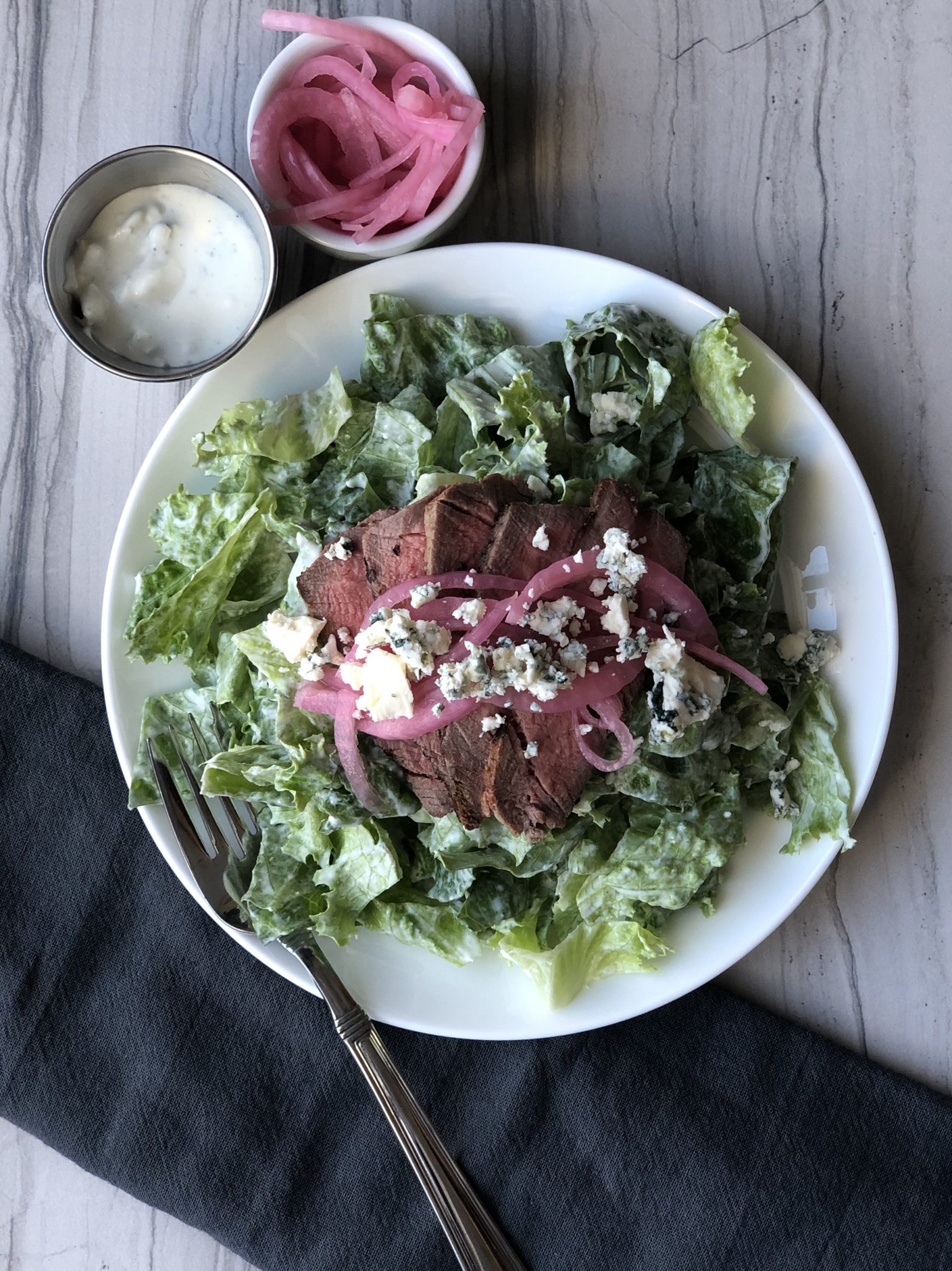 Steak and Blue Cheese Salad Topped with Marinated Red Onions